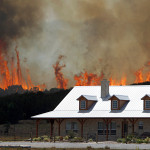 Wildfire threatens a house